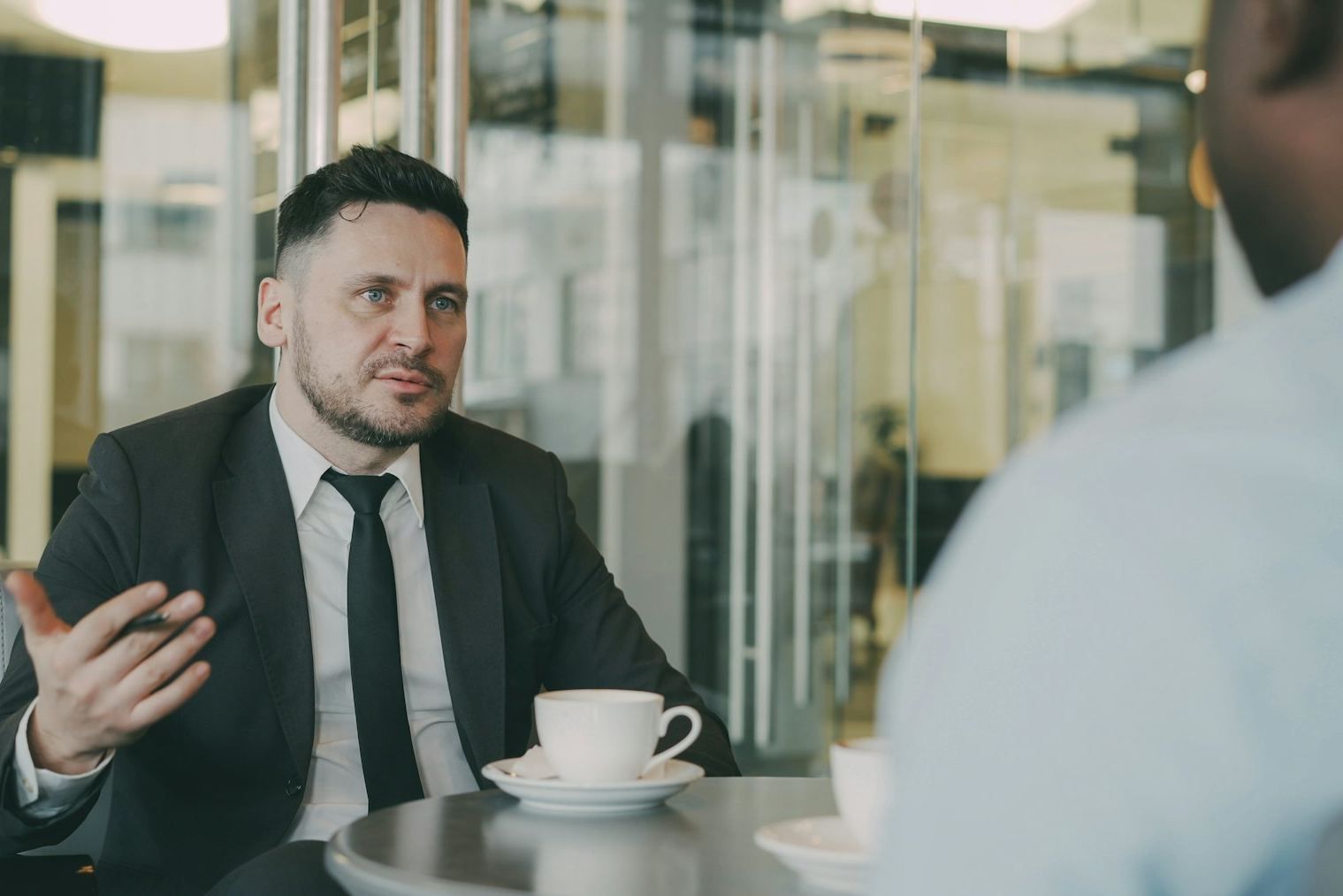Two executives in conversation over coffee