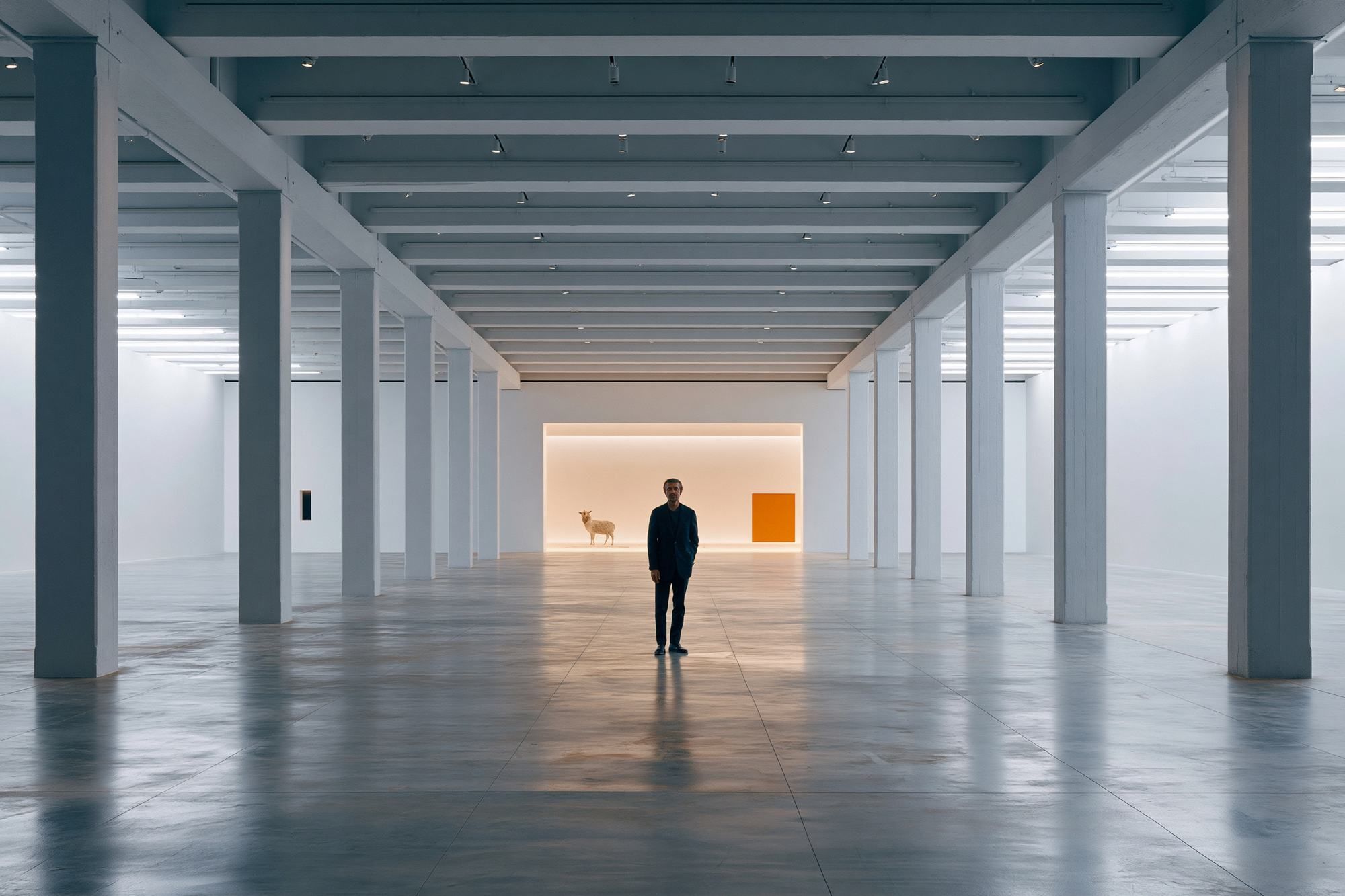 A figure at a doorway at the end of a colonnade
