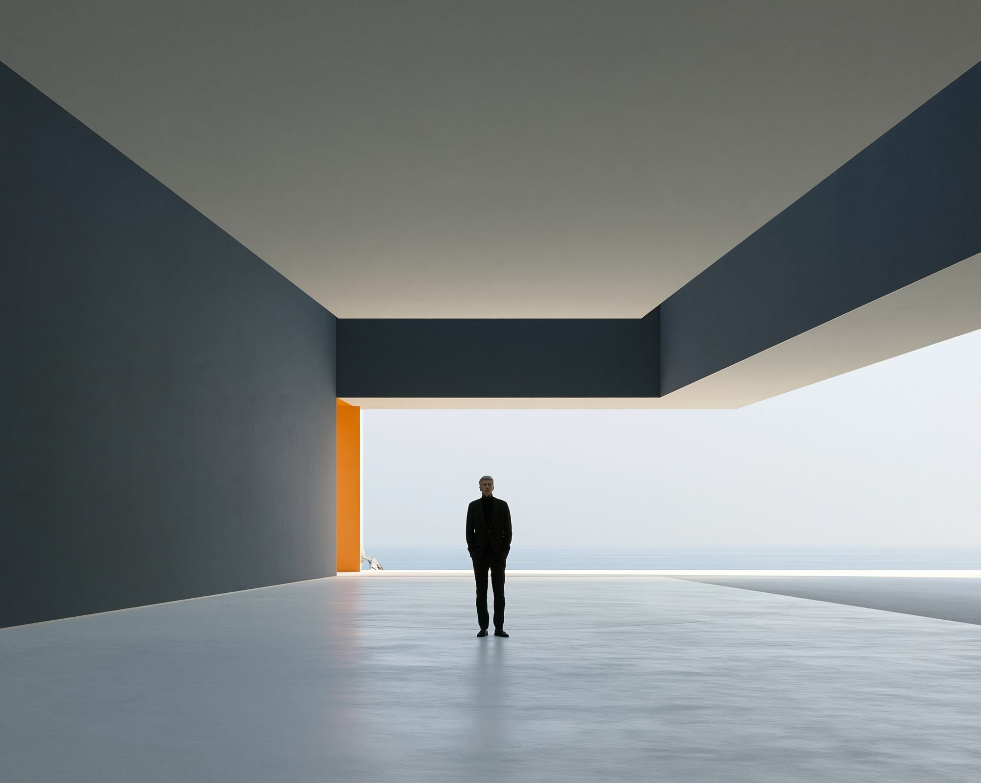 A figure under a deep concrete overhang, looking toward open water